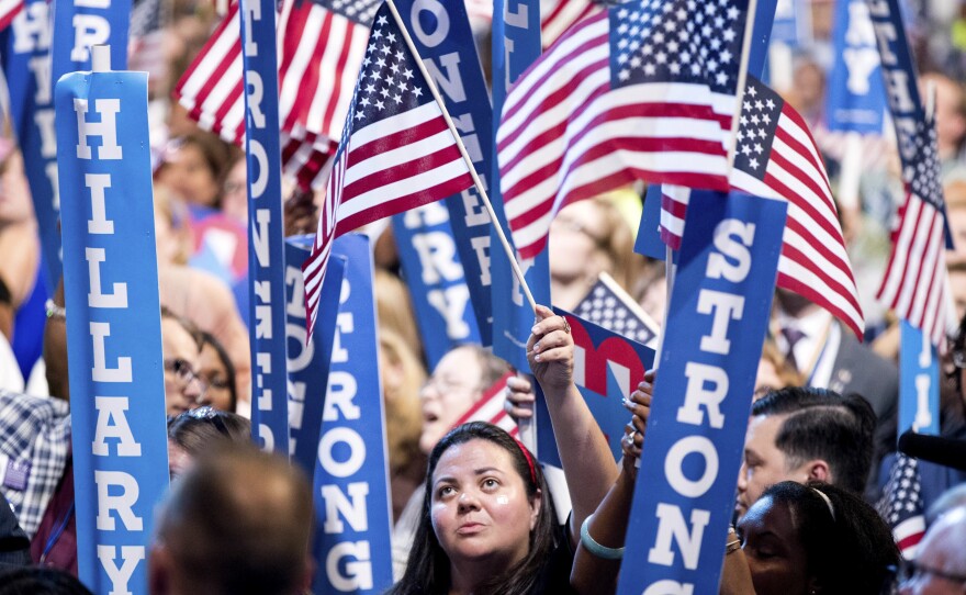 Audience members wave American flags as Democratic presidential candidate Hillary Clinton speaks on the last day of the Democratic National Convention in Philadelphia on July 28.