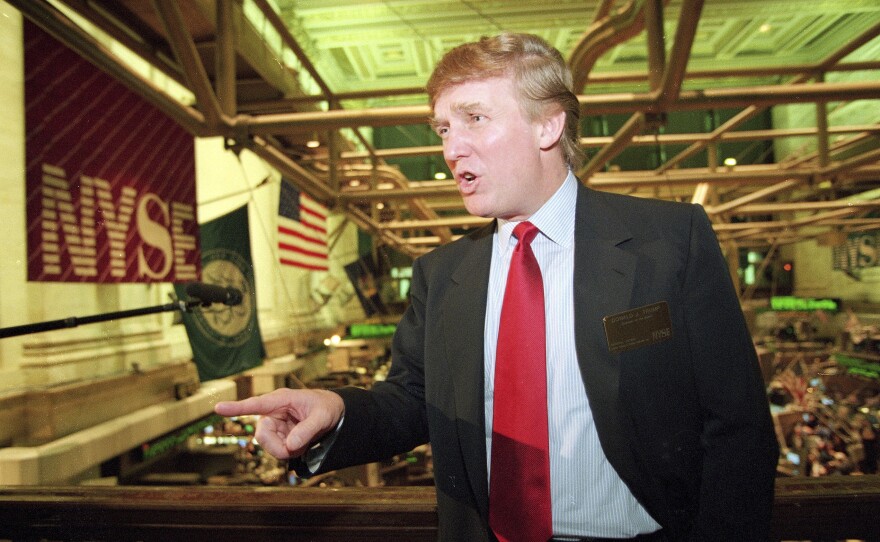 Real estate magnate Donald Trump stands above the New York Stock Exchange after taking his flagship Trump Plaza Casino public in New York City. Trump's business losses in 1995 were so large that they could have allowed him to avoid paying federal income taxes for as many as 18 years, according to records obtained by The New York Times.