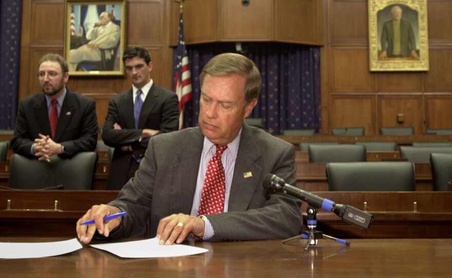 U.S. Rep. Michael Oxley, R-Ohio, signs subpoenas for WorldCom executives  in June 2002, ordering them to appear before the House Financial Services Committee. Oxley died Friday at the age of 71.