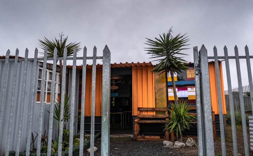 The Hot-Spot Library is made of used shipping containers connected by wood and metal. It sits between two gang territories.