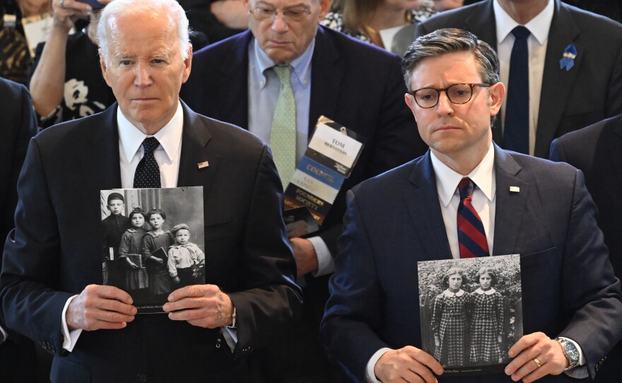 President Biden and House Speaker Mike Johnson hold images of Holocaust victims during the annual Days of Remembrance ceremony at the U.S. Capitol.