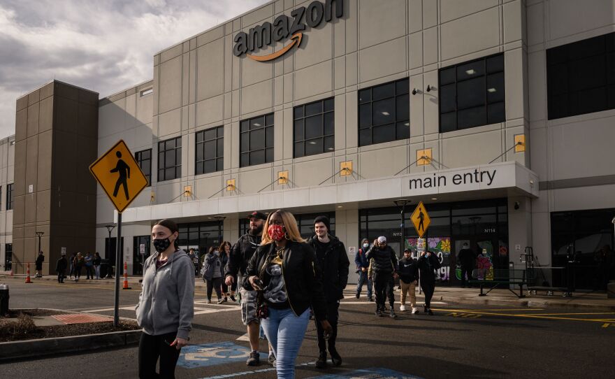 Workers walk to cast their votes over whether or not to unionize, at an Amazon warehouse on Staten Island on March 25, 2022. Another Amazon warehouse across the street began voting on a union on Monday.