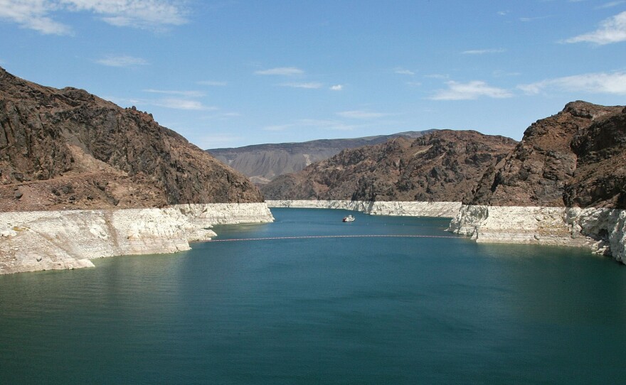 The white 'bathtub ring' on the rocks along the Colorado River is from mineral deposits left by higher levels of water.