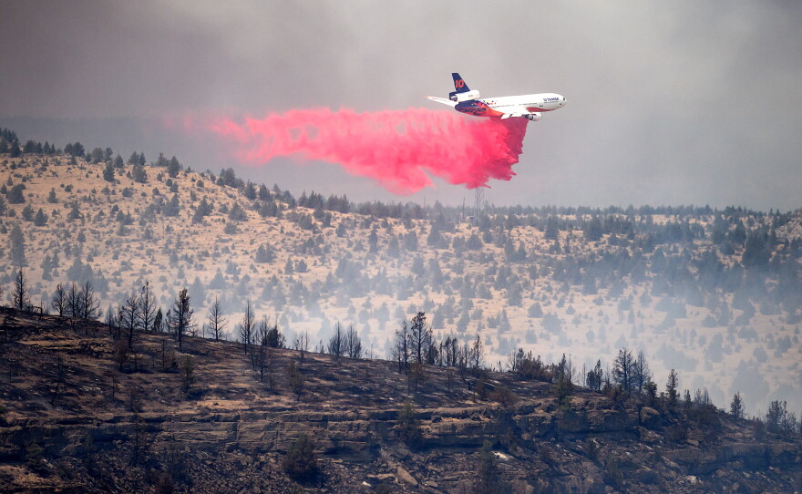 An air tanker drops retardant while battling the Bench fire on Saturday, July 25, 2026, in Jefferson County, Ore.