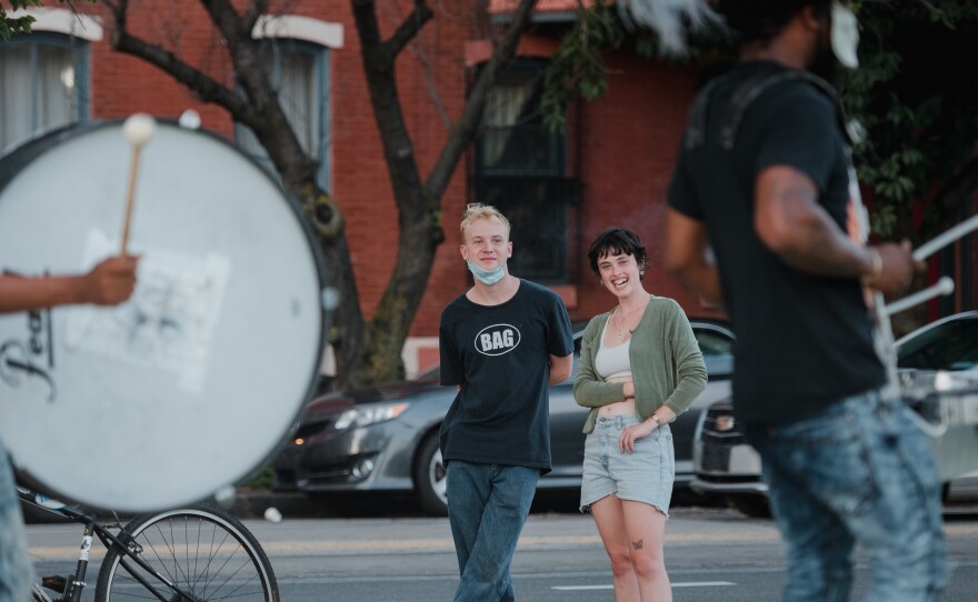 Nat Hilton (left) and Jessica Harmon came out to see the drumline and drill team in West Philadelphia.