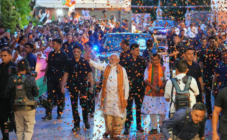 Confetti is sprayed as Indian Prime Minister Narendra Modi, center, waves to supporters upon his arrival at the Bharatiya Janata Party (BJP) headquarters to celebrate victory in the recently held state assembly elections in New Delhi, India, Monday, May 4, 2026.