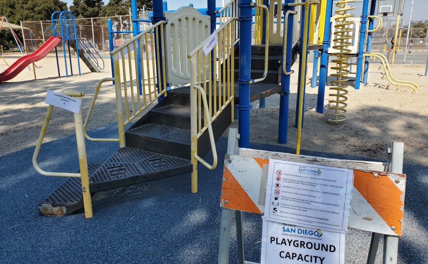 A sign advises families of coronavirus precautions at the Allied Gardens Recreation Center in San Diego County. Oct. 2, 2020.