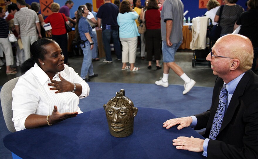 Allan Katz (right) appraises a Lanier Meaders face jug, ca. 1975, in Baltimore, Md. ANTIQUES ROADSHOW “Vintage Baltimore 2021 Hour 1” airs Monday, January 11 on PBS.