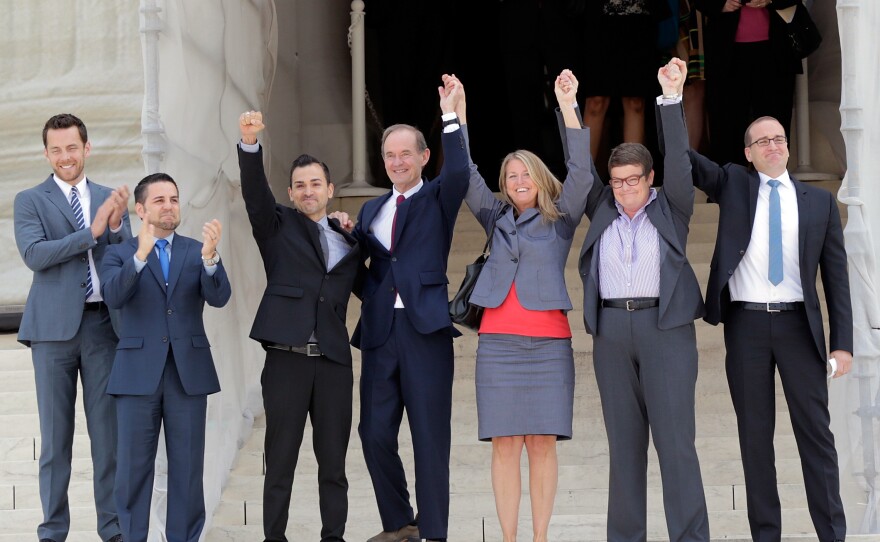 Members of the plaintiff team in the same-sex-marriage cases before the Supreme Court (from left) Adam Umhoefer, executive director of the American Foundation for Equal Rights; plaintiff Paul Katami; plaintiff Jeff Zarillo; attorney David Boies; plaintiff Kris Perry; plaintiff Sandy Stier; and Human Rights Campaign President Chad Griffin wave from the court's steps on June 26, 2013.
