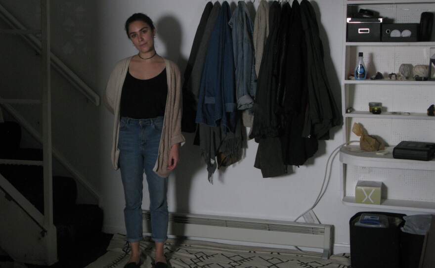 Cassandra Slack stands in the basement of her house, where she first heard the unexplained footsteps.