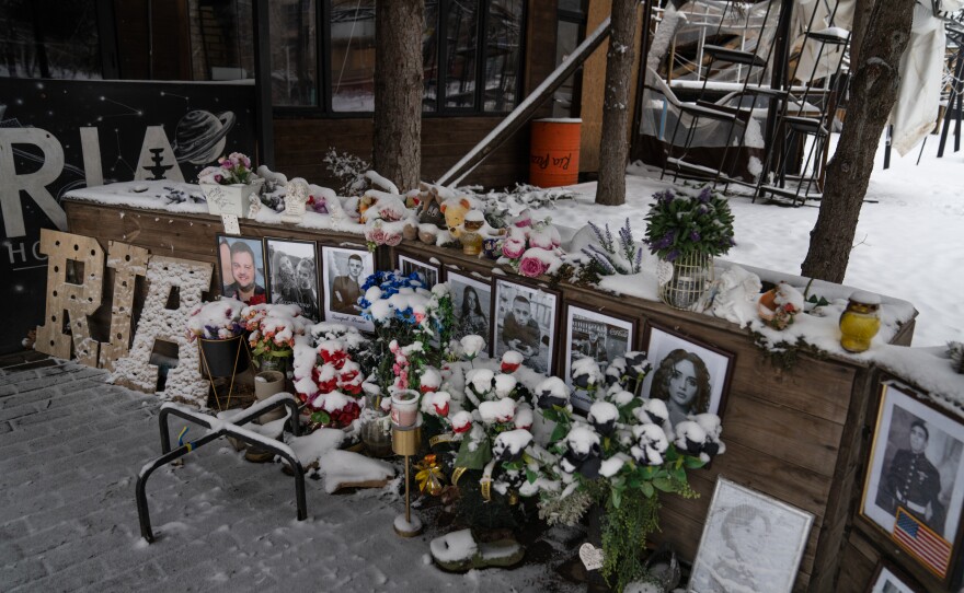 A memorial is set up among the remains of Ria Pizzeria, a beloved restaurant in Kramatorsk that was hit by a Russian strike in June 2023, killing staff and customers.