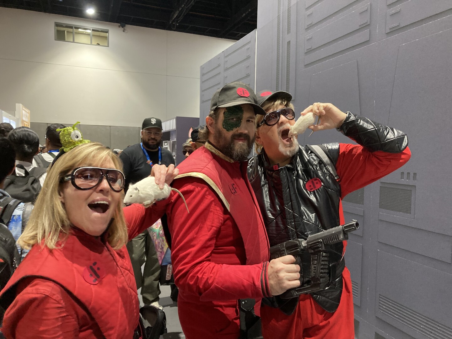A trio of cosplayers channels the 1983 sci-fi series "V," dressed as alien Visitors at Comic-Con on July 26, 2025.