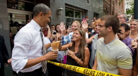 President Barack Obama greets people gathered outside of Deb's Ice Cream & Deli in Cedar Rapids, Iowa, July 10, 2012.