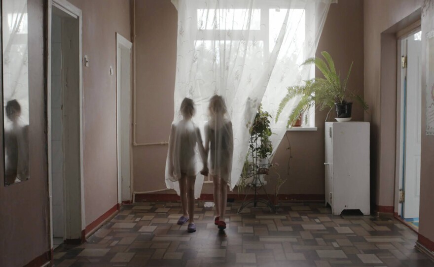 Alina and Sasha behind a curtain
