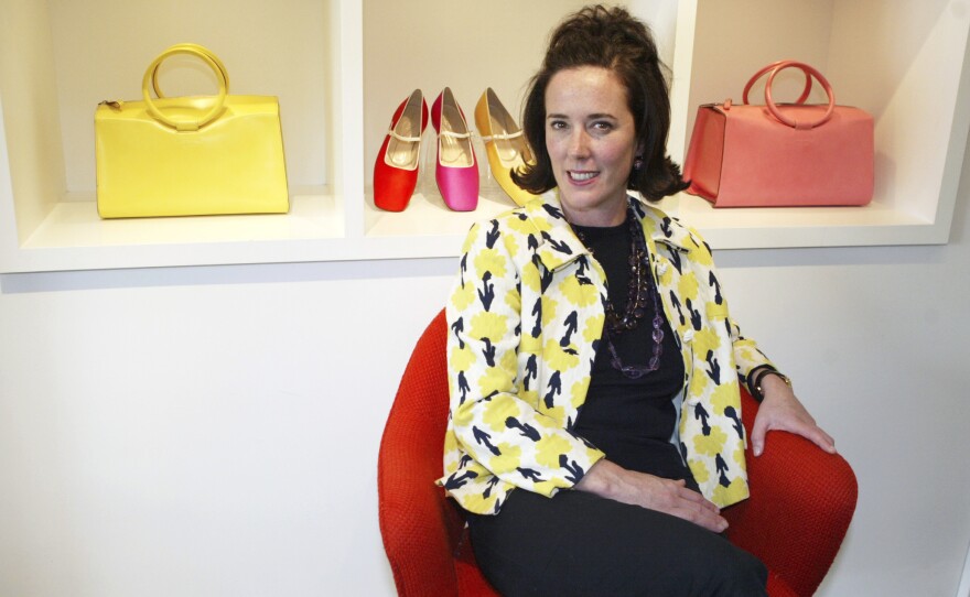 Designer Kate Spade is seen in 2004 among handbags and shoes from her collection. Spade was found dead in her New York City apartment on Tuesday. She was 55.