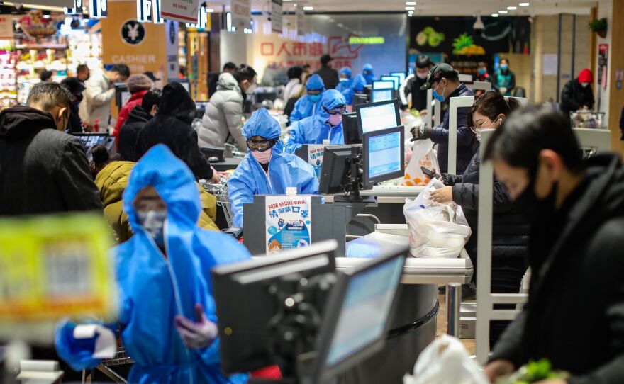 People wearing protective masks shopping at a supermarket in Shenyang in China's northeastern Liaoning province, on Monday.