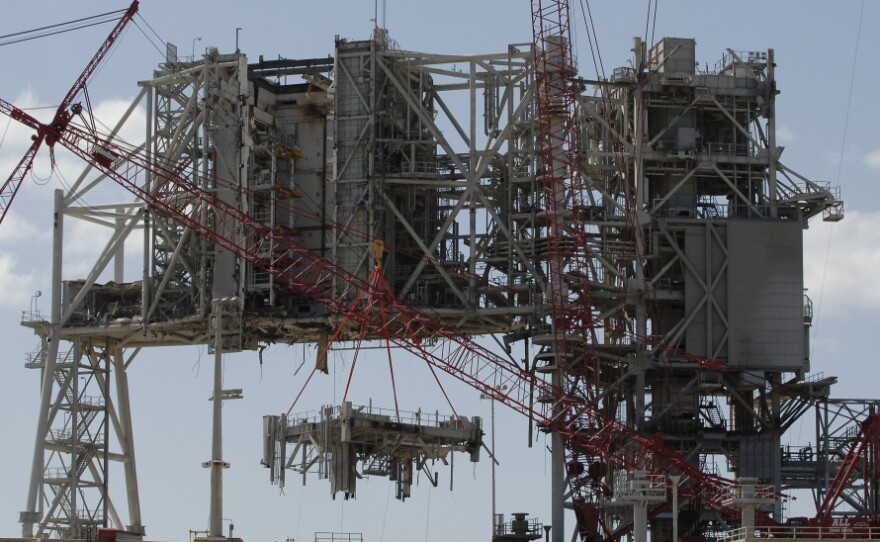 Cranes deconstruct a large section of the structure used to launch the space shuttles at launchpad 39B at Kennedy Space Center on April 6.