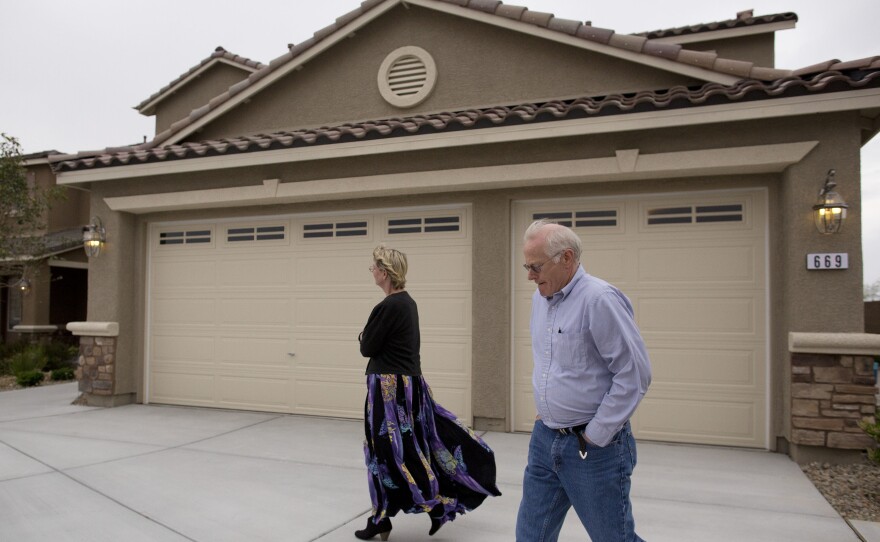 In this Friday, April 13, 2012 photo, Kelly, left, and Bill Noorish walk around a model a Lennar Next-Gen multigenerational home, in Las Vegas.