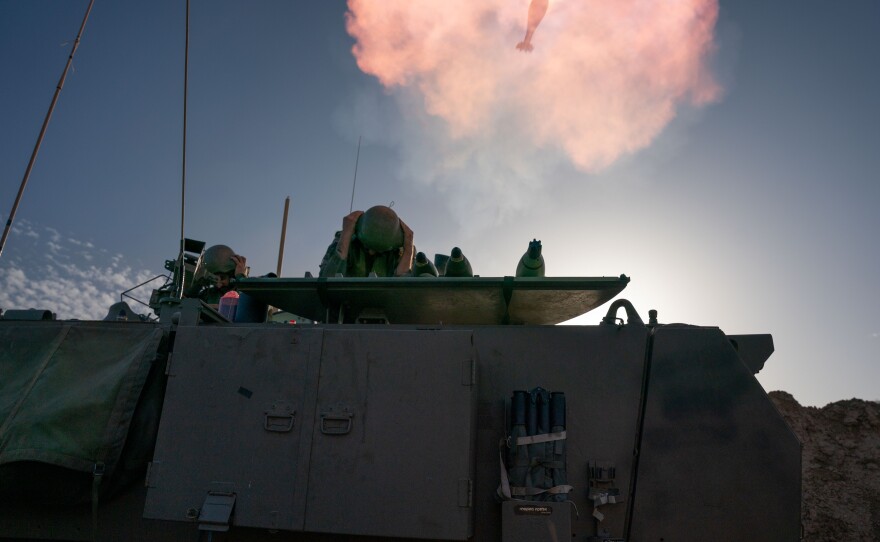 Israeli soldiers prepare and fire mortars from inside Israel into Gaza, backing up troops near the Maghazi refugee camp on Monday.