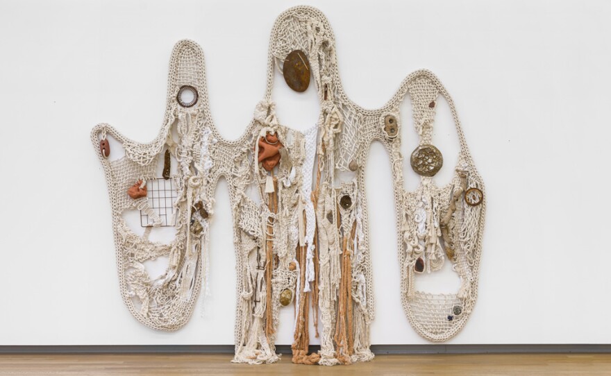 Tanya Aguiñiga's "Somos una tela continua" (2023) is on view in "Border Craft" at UC San Diego's Mandeville Art Gallery. It's made primarily of rope and sculptural objects woven into the sculpture, hanging from the wall.