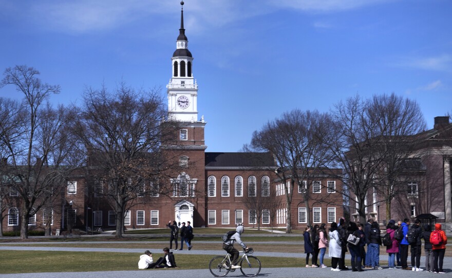A tour group makes its way through Dartmouth College's campus, in Hanover, N.H., in April 2023.