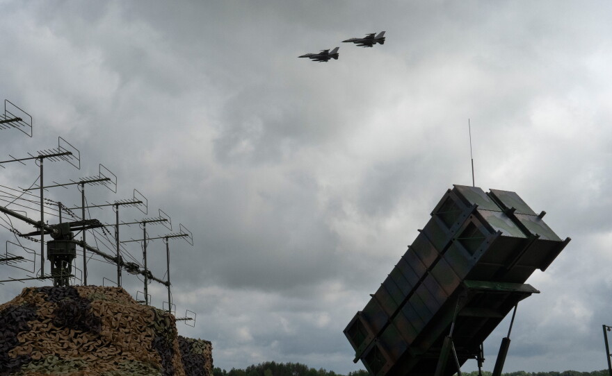 Ukrainian Air Force F-16 fighter jets fly over a Patriot air and missile defense system in an undisclosed location in Ukraine, on Aug. 4, 2024.