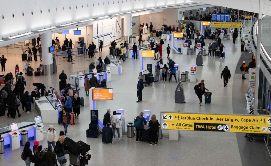 Travelers arrive at John F. Kennedy International Airport on January 11, 2023, in New York.
