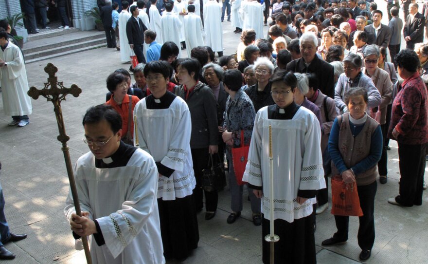 Clergy from the government-sanctioned Catholic church hold a procession up to the Sheshan basilica, on the outskirts of Shanghai. Chinese Catholics, long divided between those who recognize the authority of the Vatican and those who belong to the government-sanctioned church, are beginning the slow process of reconciliation.