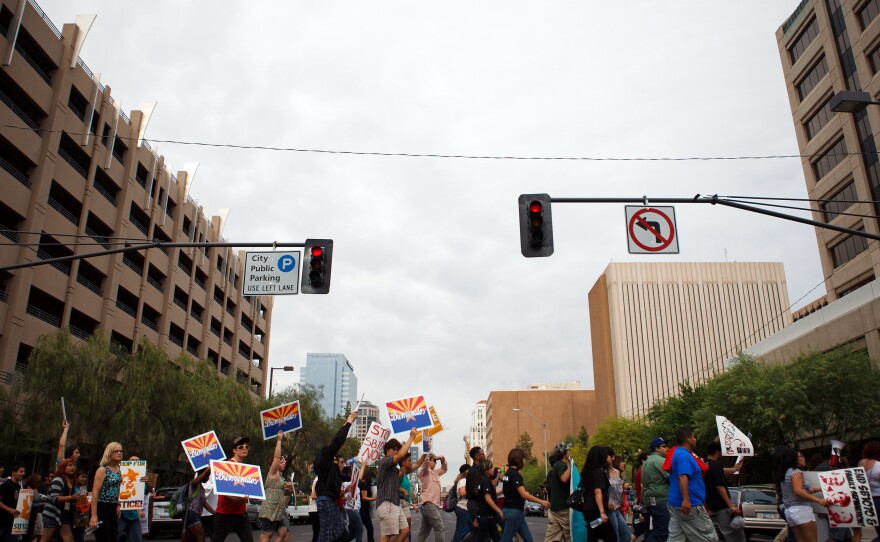 Protesters opposed to Arizona's immigration law march through downtown Phoenix on April 25, the day the U.S. Supreme Court heard arguments over the law.
