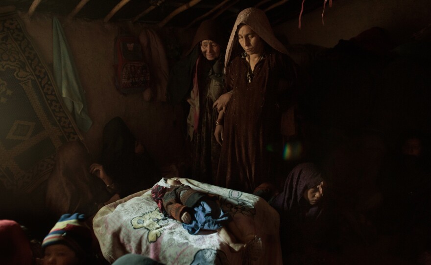 At 3 months of age, Khan Mohammad passed away because of the cold in Kabul, Afghanistan. His mother is comforted before the child is washed and buried in a camp for displaced persons in Kabul, Afghanistan. The family had fled the war in southern Afghanistan. But the winter of 2011-2012 was deadly for refugees living without proper housing or heat. February 8, 2012