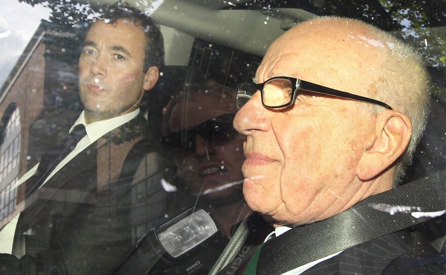 Media mogul Rupert Murdoch (right) rides with Will Lewis, then the general manager of Murdoch's News International and now <em>The Washington Post</em>'s CEO, in July 2011.