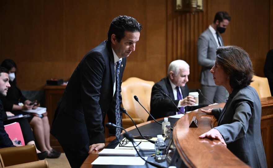 Democratic Sen. Brian Schatz of Hawaii, left, speaks with Commerce Secretary Gina Raimondo, who oversees the Census Bureau, before a Senate Appropriations subcommittee hearing on Capitol Hill in Washington, D.C., in May.