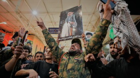An Iraqi Shiite soldier chants on the eve of funeral ceremonies for the late Iranian Supreme Leader Ayatollah Ali Khamenei outside the Imam Ali Shrine in Najaf, Iraq, Tuesday, July 7, 2026.