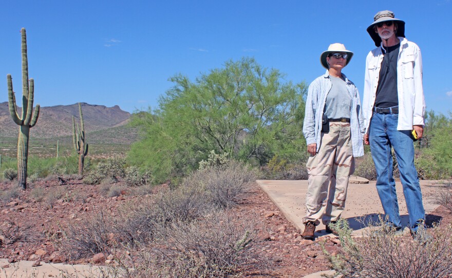 Owen (left) and Penson stand on marker "Y57," located at the southwestern edge of a massive 289-square-mile grid of concrete X's.