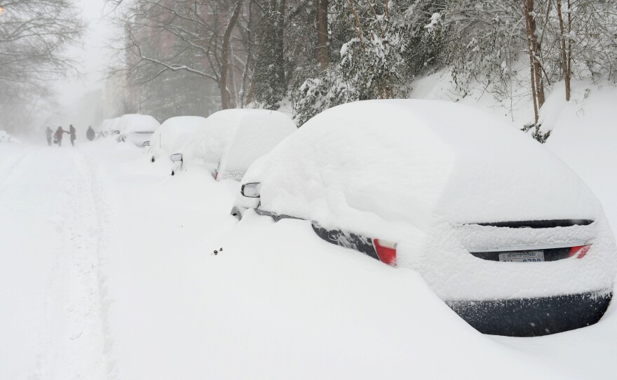 Snow-covered cars line a residential street in the northwest of Washington, D.C., on Jan. 23.