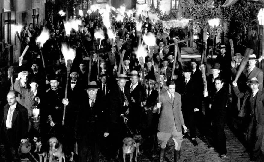 Angry villagers — like these, from James Whale's classic 1931 film version of <em>Frankenstein</em>.