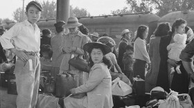 Japanese families in Woodland, California wait for train at railroad station to take them to internment camp. May, 20 1942.<br/>
