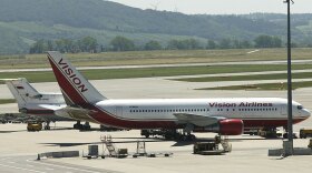 A Vision airlines plane presumed to be carrying 10 men and women who worked as Russian spies in the United States sits on the tarmac at Vienna airport where it parked next to a Russian jetplane.