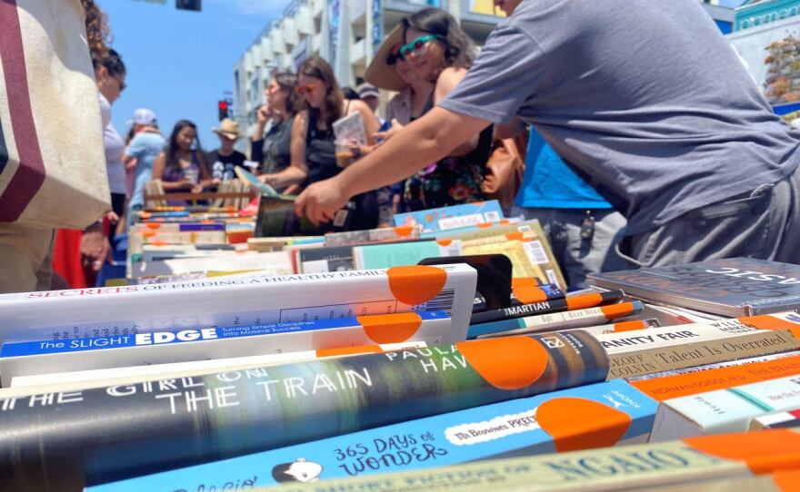 Patrons browse through books at the summer North Park book fair, July 17, 2021.