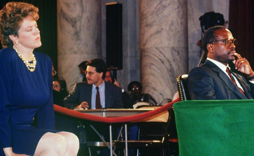 Supreme Court nominee Clarence Thomas is flanked by his wife Ginni during his confirmation hearings in 1991. Ginni Thomas requested law professor Anita Hill apologize for filing sexual harassment charges against her husband.