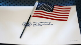 An information packet and an American flag are placed on a chair at the U.S. Citizenship and Immigration Services Miami Field Office on Aug. 17, 2018, in Miami.