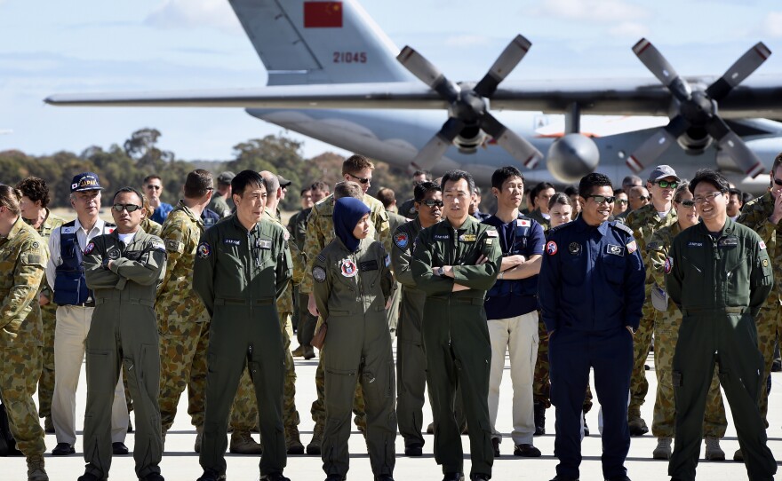 International and Australian aircrews involved in the search for the missing Malaysia Airlines plane on the tarmac at the Royal Australian Air Force Pierce Base in Bullsbrook, near Perth, on Tuesday.