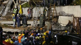 Rescue personnel work on the rescue of a trapped child at the collapsed Enrique Rebsamen primary schoool in Mexico City, Sept. 20, 2017.