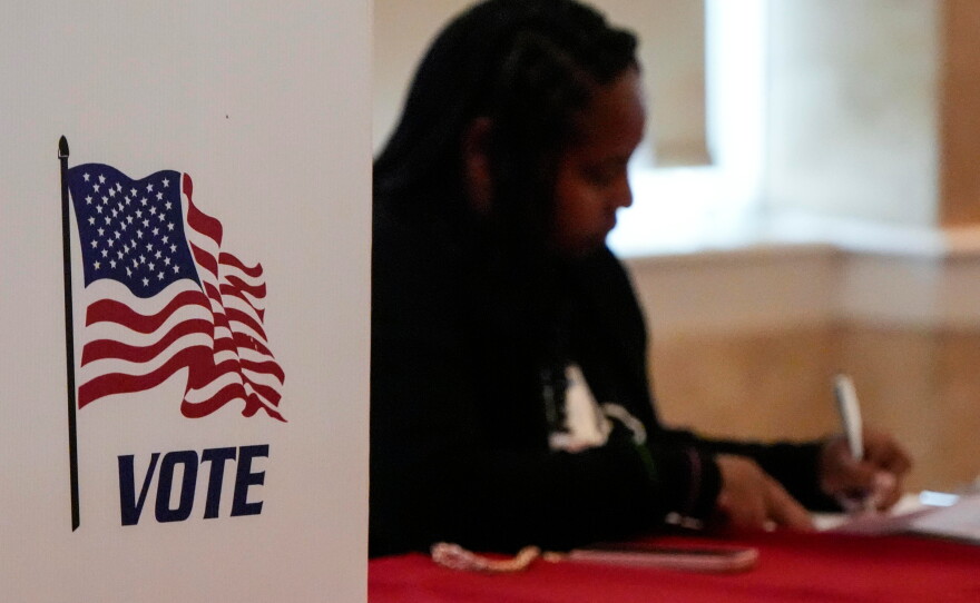 A Fulton County, Ga. staff member works as people vote in a runoff election in Atlanta on June 16, 2026.