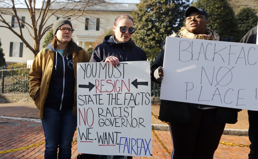 Demonstrators hold signs and chant in Richmond, Va., on Feb. 2. They were calling for the resignation of Gov. Ralph Northam after a racist photo on his medical school yearbook page came to light. He denies that he is in the photo but admits to once dressing in blackface.