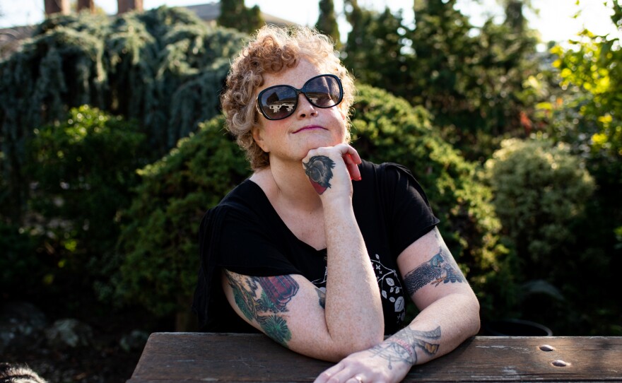 Sassy Outwater-Wright sits at a picnic table in her backyard in Berkeley on Jan. 20, 2022. Treatment for cancer has weakened her immunity.