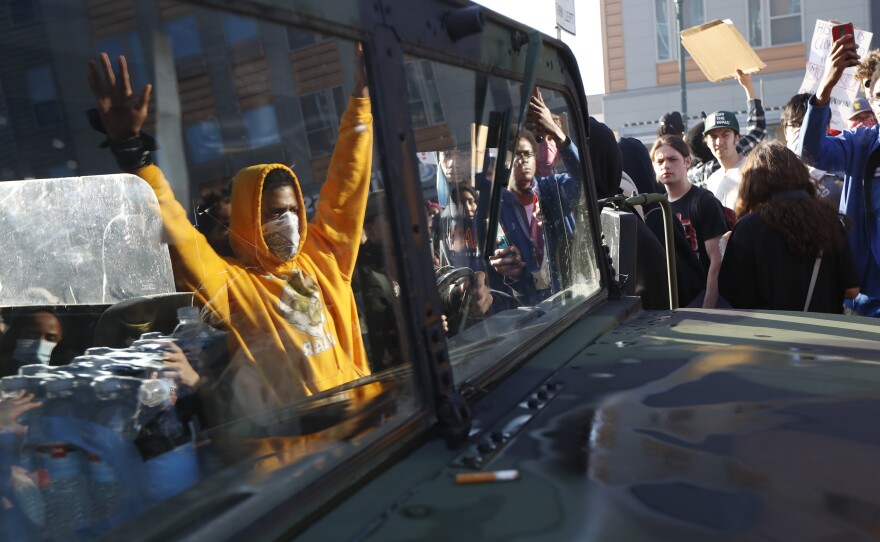 A National Guard vehicle reflects a crowd of protesters Friday in Minneapolis, where Maj. Gen. Jon Jensen said that night's deployment "was not enough" to handle the massive protests over the death of George Floyd.