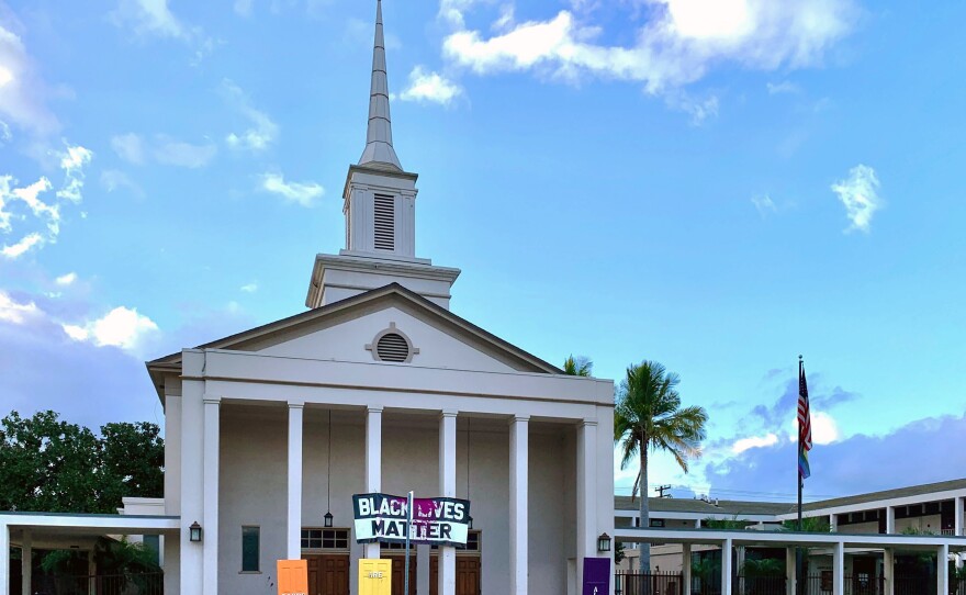 The front of the University Christian Church with its Black Lives Matter banner and rainbow color doors vandalized as seen in this photo taken Jan. 24, 2021.