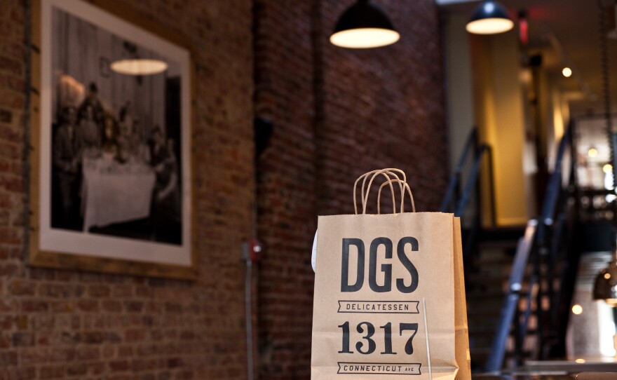 An earlier generation of deli owners, and relatives of the DGS partners, keeps watch over a to-go bag at the restaurant's walk-up counter.