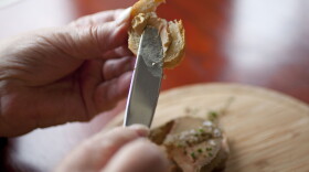 This file photo shows Karlene Bley of Los Angeles spread her torchon of foie gras onto bread during lunch at the Presidio Social Club restaurant in San Francisco, July 17, 2012. 
